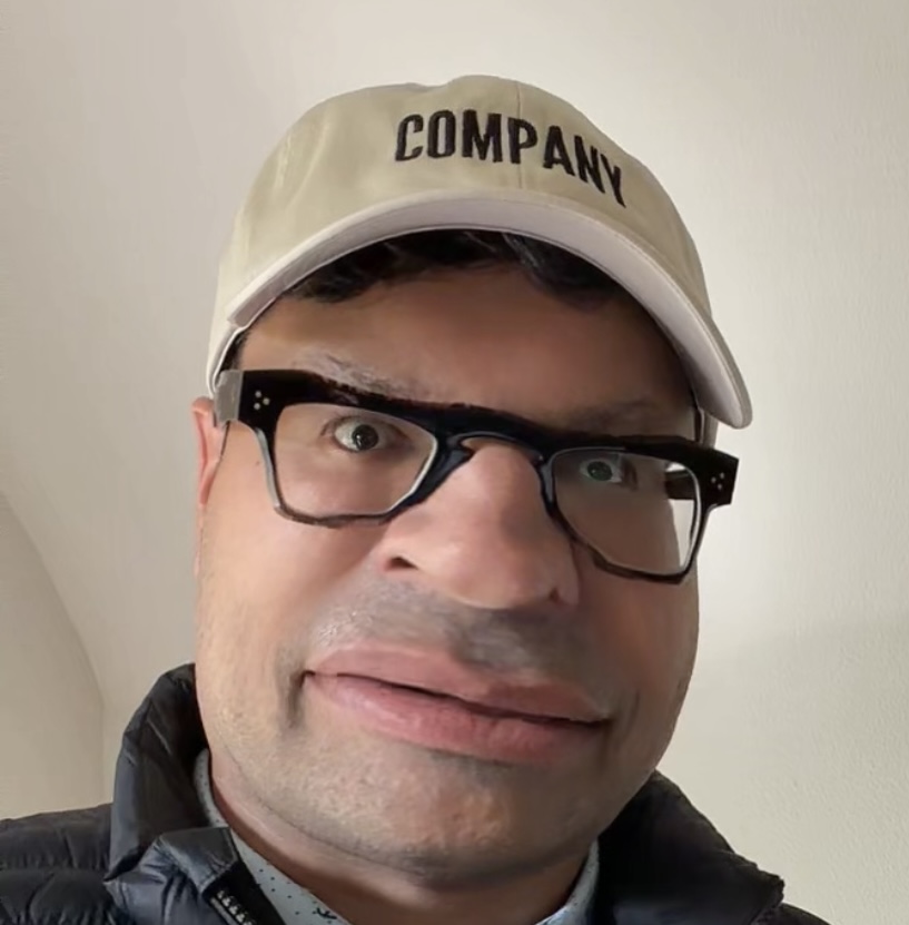 Tech VP wearing glasses and a COMPANY cap
